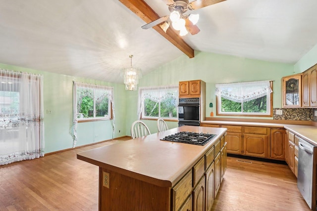 602 Daisy Ln, Round Lake Beach, IL 60073 - kitchen with gas cooktop, dishwasher, light wood-style floors, light countertops, and a center island