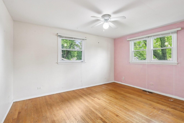 602 Daisy Ln, Round Lake Beach, IL 60073 - unfurnished room with light wood finished floors and a ceiling fan