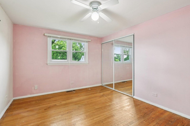 602 Daisy Ln, Round Lake Beach, IL 60073 - unfurnished bedroom featuring light wood finished floors, a closet, and ceiling fan