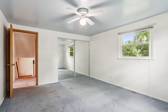 602 Daisy Ln, Round Lake Beach, IL 60073 - unfurnished bedroom with multiple windows, carpet, a closet, and a ceiling fan