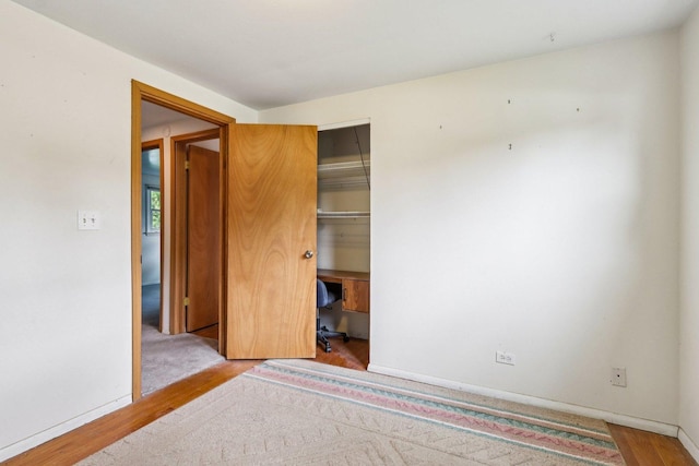 602 Daisy Ln, Round Lake Beach, IL 60073 - unfurnished bedroom with a closet and wood finished floors
