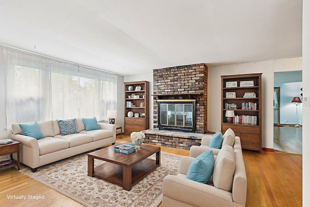 602 Daisy Ln, Round Lake Beach, IL 60073 - living room with light wood-type flooring, a fireplace, and built in features