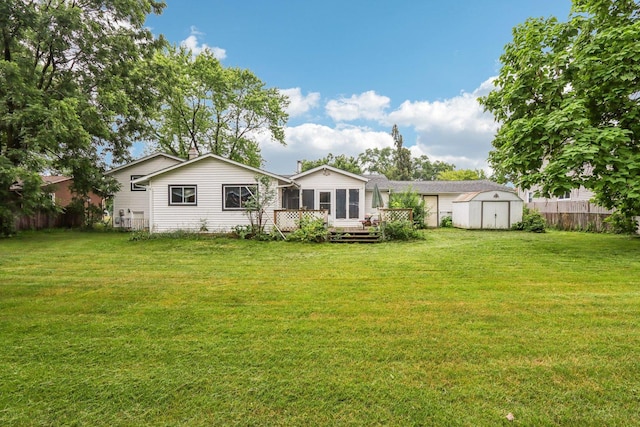 602 Daisy Ln, Round Lake Beach, IL 60073 - rear view of house with a storage unit and a wooden deck