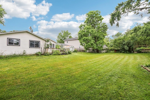 602 Daisy Ln, Round Lake Beach, IL 60073 - view of yard featuring a deck and a shed
