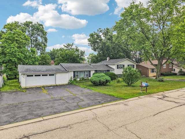 602 Daisy Ln, Round Lake Beach, IL 60073 - split level home with asphalt driveway, an attached garage, and a front yard