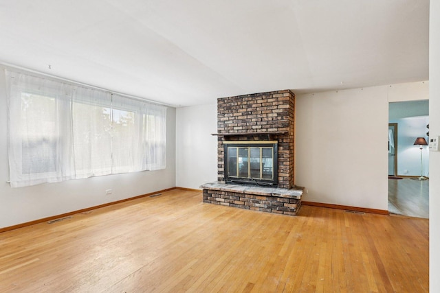 602 Daisy Ln, Round Lake Beach, IL 60073 - unfurnished living room featuring hardwood / wood-style floors and a fireplace