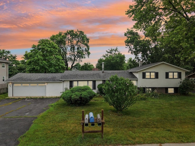 602 Daisy Ln, Round Lake Beach, IL 60073 - tri-level home featuring asphalt driveway, a garage, and a front lawn