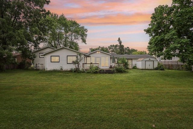 602 Daisy Ln, Round Lake Beach, IL 60073 - rear view of house with a storage unit and a deck