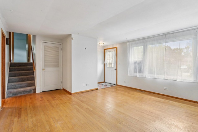 602 Daisy Ln, Round Lake Beach, IL 60073 - empty room featuring light wood-style floors and stairs
