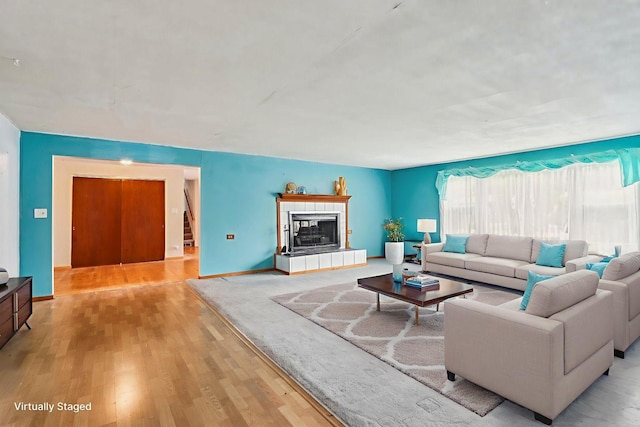 602 Daisy Ln, Round Lake Beach, IL 60073 - living area with light wood finished floors and a tiled fireplace
