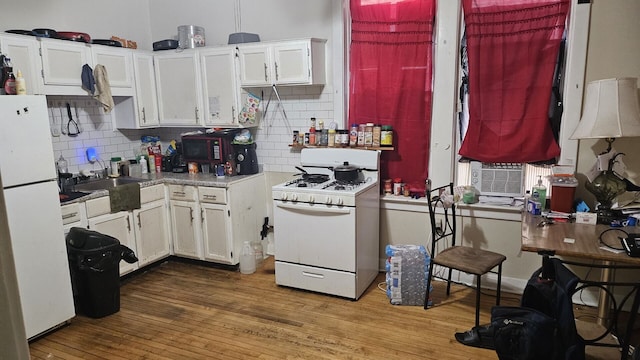 2536 S Avers Ave, Chicago, IL 60623 - kitchen with white appliances, white cabinetry, decorative backsplash, and wood-type flooring