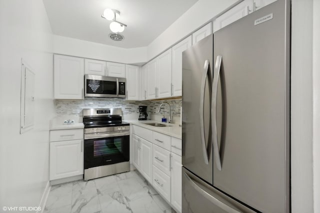 5950 N Kenmore Ave Unit 306, Chicago, IL 60660 - kitchen with stainless steel appliances, light marble finish flooring, white cabinetry, and light countertops