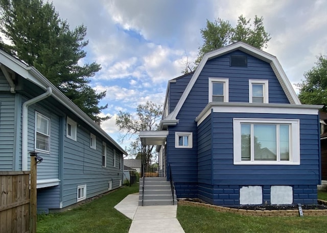 411 W 116th St, Chicago, IL 60628 - view of front of property with a gambrel roof and a front yard