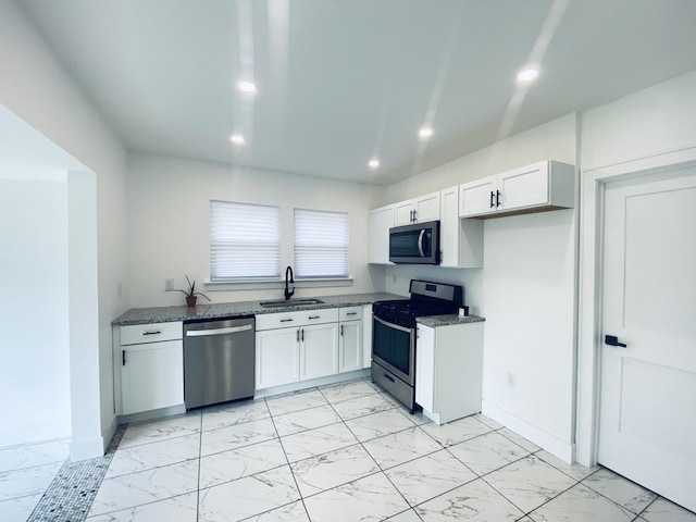 411 W 116th St, Chicago, IL 60628 - kitchen with stainless steel appliances, light marble finish flooring, recessed lighting, white cabinets, and dark stone countertops