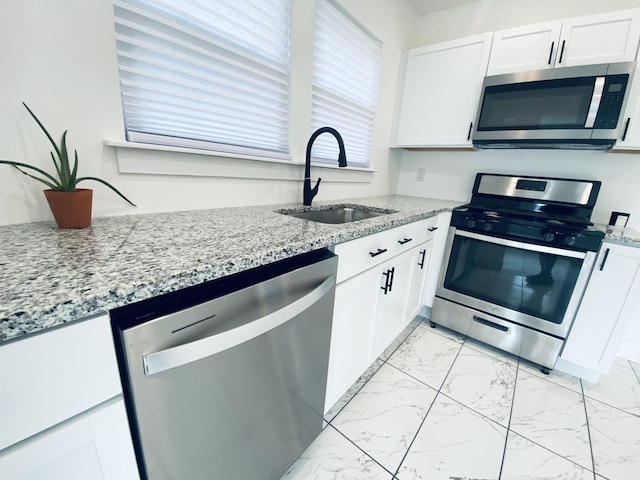 411 W 116th St, Chicago, IL 60628 - kitchen with appliances with stainless steel finishes, light marble finish floors, and white cabinets