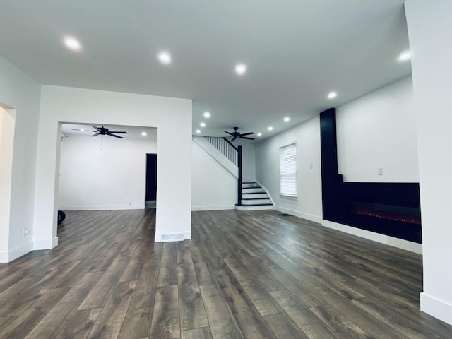411 W 116th St, Chicago, IL 60628 - below grade area featuring ceiling fan, stairway, dark wood-type flooring, a warm lit fireplace, and recessed lighting