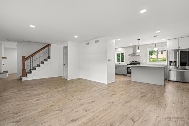 154 Newton Ave, Glen Ellyn, IL 60137 - unfurnished living room featuring recessed lighting, light wood finished floors, and stairs