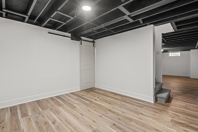 154 Newton Ave, Glen Ellyn, IL 60137 - basement with a barn door, stairway, and wood finished floors
