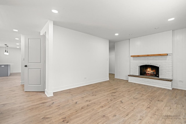 154 Newton Ave, Glen Ellyn, IL 60137 - unfurnished living room featuring light wood-style flooring, recessed lighting, and a brick fireplace