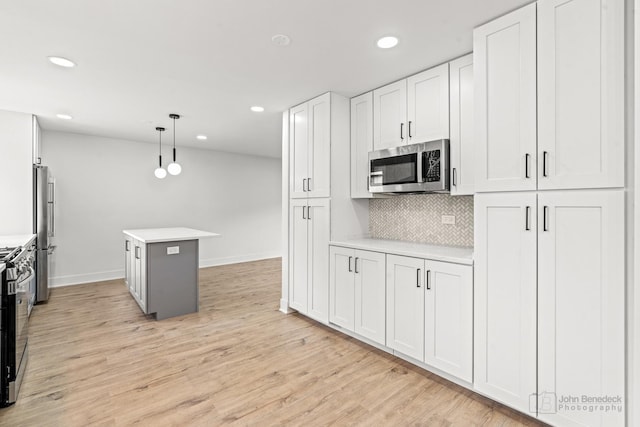 154 Newton Ave, Glen Ellyn, IL 60137 - kitchen featuring stainless steel appliances, recessed lighting, light countertops, a center island, and decorative backsplash