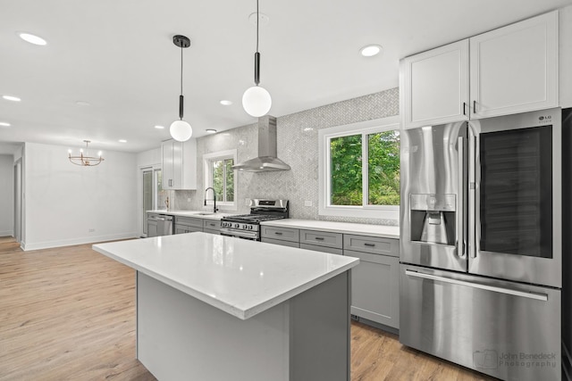 154 Newton Ave, Glen Ellyn, IL 60137 - kitchen featuring stainless steel appliances, wall chimney range hood, light countertops, light wood-type flooring, and recessed lighting
