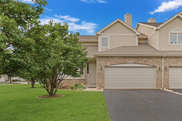 6406 Cunningham Ct, Gurnee, IL 60031 - view of front of home with brick siding, driveway, a shingled roof, a front lawn, and a garage