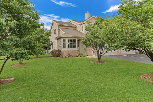 6406 Cunningham Ct, Gurnee, IL 60031 - view of front facade featuring asphalt driveway, a front yard, a chimney, and roof with shingles
