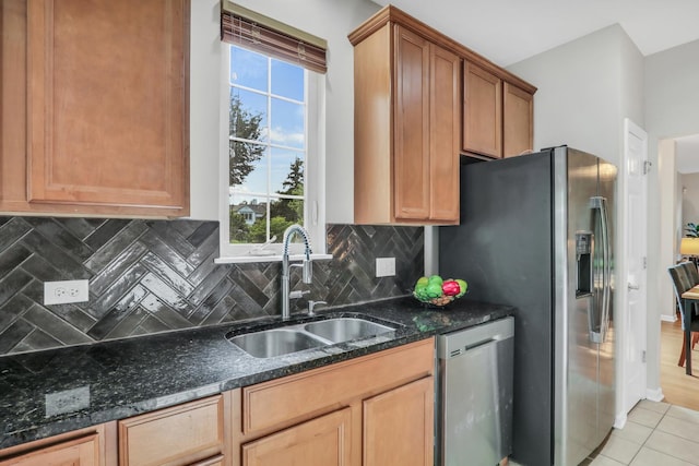6406 Cunningham Ct, Gurnee, IL 60031 - kitchen with appliances with stainless steel finishes, decorative backsplash, light tile patterned flooring, and dark stone counters