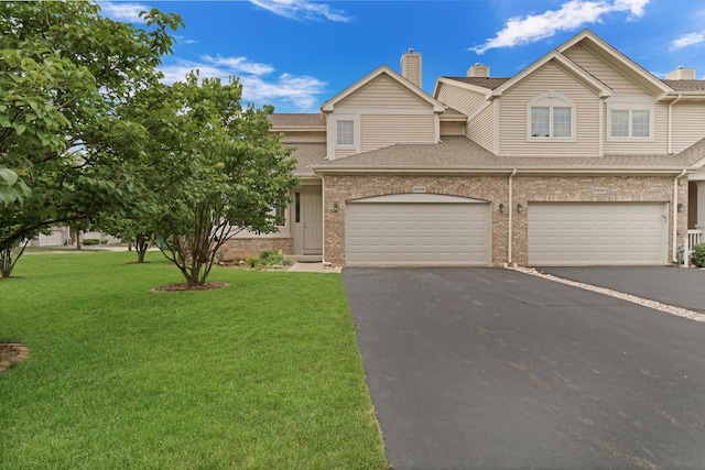 6406 Cunningham Ct, Gurnee, IL 60031 - view of front facade with brick siding, a front lawn, driveway, roof with shingles, and a garage