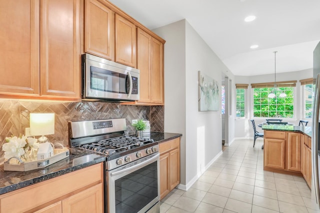 6406 Cunningham Ct, Gurnee, IL 60031 - kitchen featuring stainless steel appliances, decorative backsplash, dark stone counters, light tile patterned floors, and recessed lighting