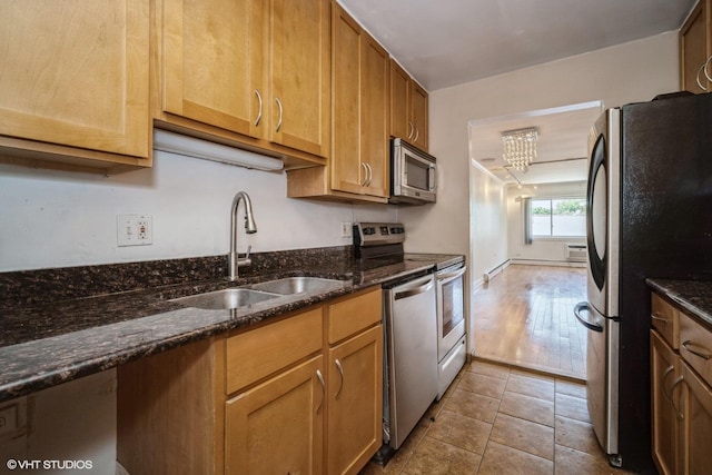 1508 W Pratt Blvd Unit 2C, Chicago, IL 60626 - kitchen featuring stainless steel appliances, dark stone countertops, and tile patterned flooring