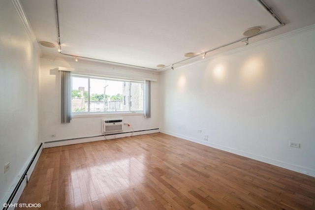 1508 W Pratt Blvd Unit 2C, Chicago, IL 60626 - spare room with rail lighting, a baseboard heating unit, light wood-type flooring, ornamental molding, and a wall mounted AC