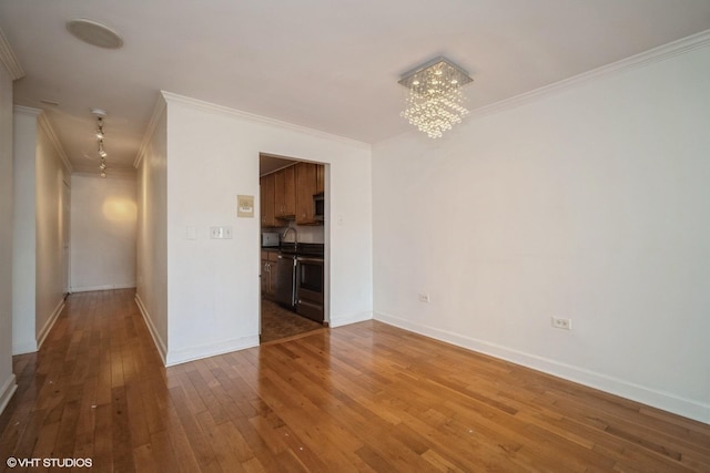 1508 W Pratt Blvd Unit 2C, Chicago, IL 60626 - spare room with ornamental molding, a chandelier, and hardwood / wood-style floors