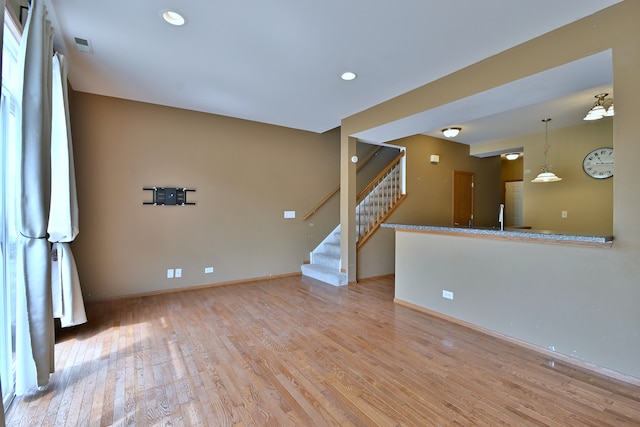 2224 Flagstone Ln Unit 2224, Carpentersville, IL 60110 - unfurnished living room featuring wood finished floors, stairs, and recessed lighting