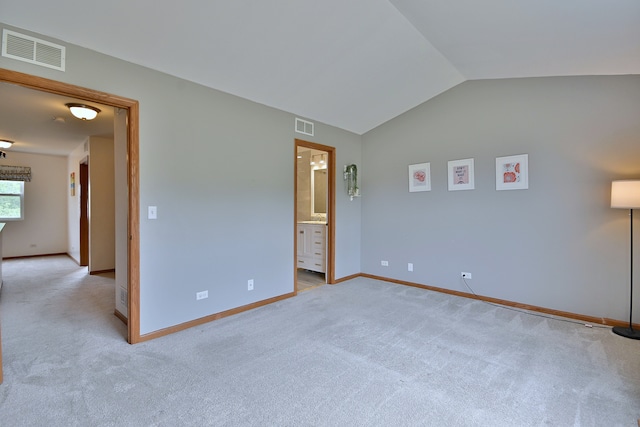 2224 Flagstone Ln Unit 2224, Carpentersville, IL 60110 - unfurnished bedroom featuring light carpet, lofted ceiling, and connected bathroom