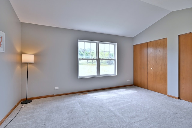 2224 Flagstone Ln Unit 2224, Carpentersville, IL 60110 - unfurnished bedroom with vaulted ceiling, carpet, and two closets