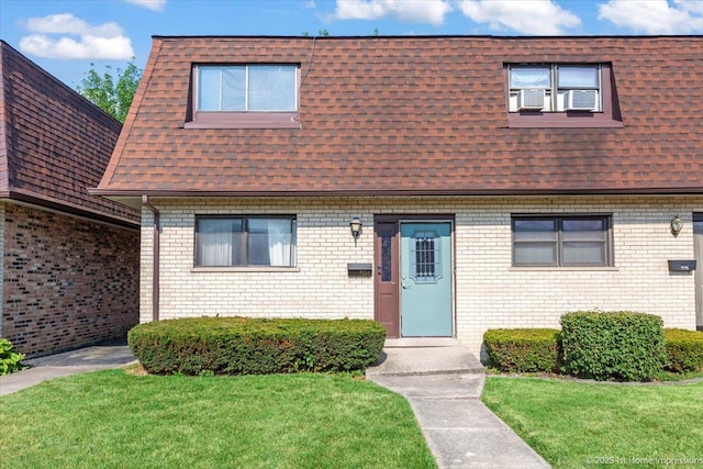 7526 S Cork Ave Unit 7526, Justice, IL 60458 - view of property featuring a shingled roof, mansard roof, a front lawn, and brick siding
