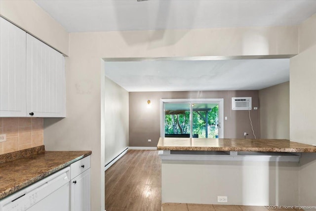 7526 S Cork Ave Unit 7526, Justice, IL 60458 - kitchen with white dishwasher, a wall mounted AC, white cabinetry, tasteful backsplash, and light wood-type flooring