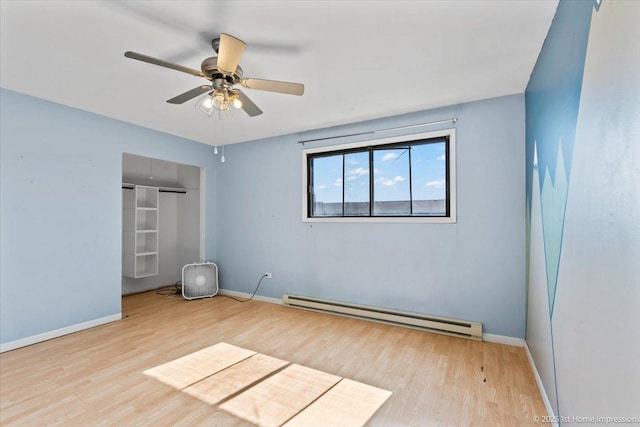7526 S Cork Ave Unit 7526, Justice, IL 60458 - spare room with a baseboard heating unit, wood finished floors, and ceiling fan