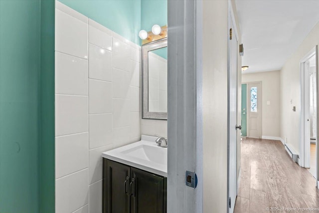7526 S Cork Ave Unit 7526, Justice, IL 60458 - bathroom with vanity, a baseboard radiator, and wood finished floors