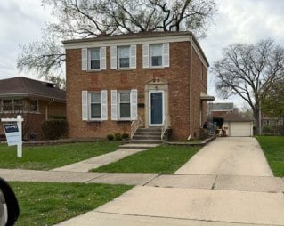 1518 Cleveland Ave, La Grange Park, IL 60526 - view of front of property with a front yard, a garage, brick siding, and driveway