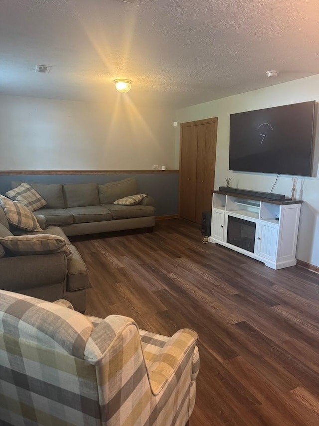 815 Arnold Ave, Rockford, IL 61108 - living area featuring wood finished floors, a textured ceiling, and a fireplace