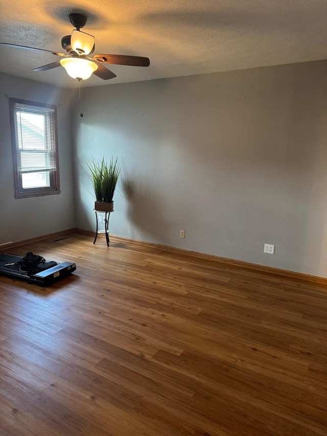 815 Arnold Ave, Rockford, IL 61108 - unfurnished room with wood finished floors, ceiling fan, and a textured ceiling