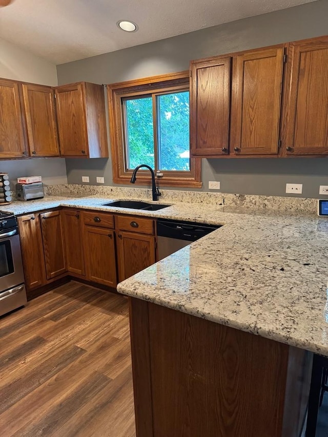 815 Arnold Ave, Rockford, IL 61108 - kitchen featuring stainless steel appliances, brown cabinets, dark wood-type flooring, light stone countertops, and recessed lighting