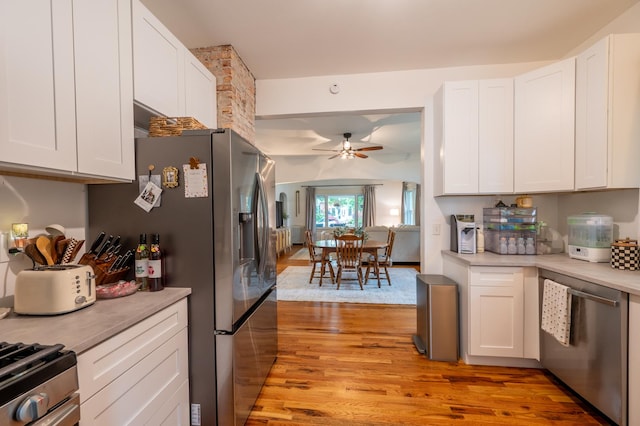102 E Front St, Mount Morris, IL 61054 - kitchen with stainless steel appliances, a ceiling fan, light wood-style floors, and white cabinets