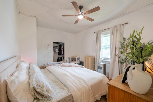 102 E Front St, Mount Morris, IL 61054 - bedroom featuring radiator heating unit, a ceiling fan, and a spacious closet