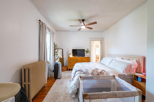 102 E Front St, Mount Morris, IL 61054 - bedroom with radiator, wood finished floors, ornamental molding, and a ceiling fan