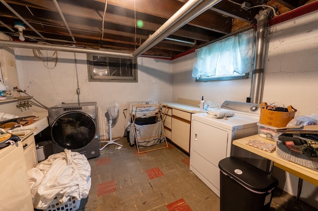 102 E Front St, Mount Morris, IL 61054 - laundry room with washing machine and dryer, cabinet space, and dark flooring