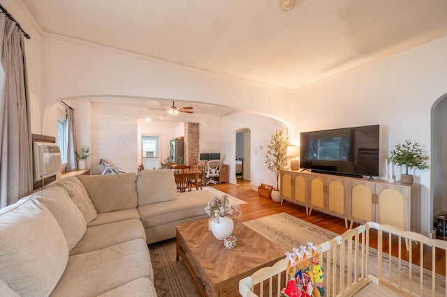 102 E Front St, Mount Morris, IL 61054 - living room with arched walkways, wood finished floors, ceiling fan, and ornamental molding