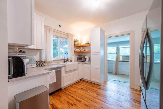 102 E Front St, Mount Morris, IL 61054 - kitchen featuring appliances with stainless steel finishes, light wood-style floors, light countertops, white cabinetry, and open shelves